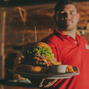 Restaurant server holding a hamburger